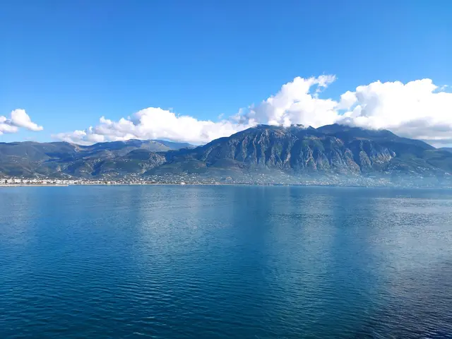 Aerial view of Voidokilia Beach with its iconic omega-shaped coastline and turquoise waters in Messinia, Greece